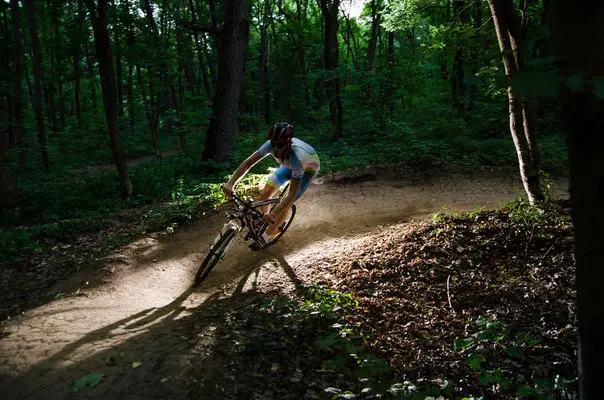 Man bikes in the forest