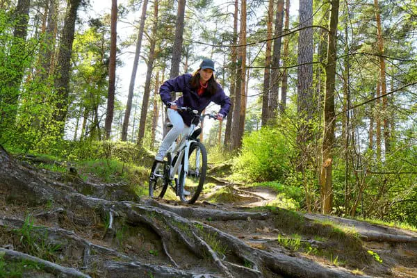 woman on bike in forest